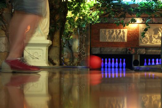 A bowling lane with ball pins and ball return.