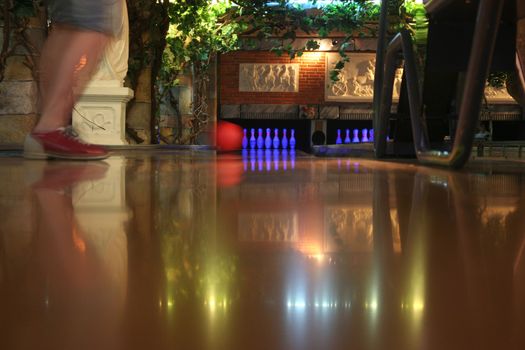 A bowling lane with ball pins and ball return.