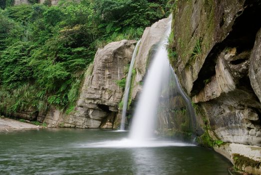 It is a beautiful waterfall over the river.