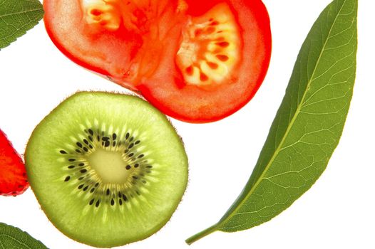 Bay tree leaf, kiwi and tomato transparent slices over white