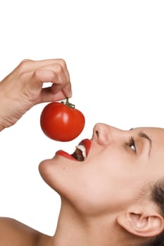 Young Woman Eating Tomatoes. Portrait of smiling attractive young woman with ripe tomato, white background, freshness and healthy food concept