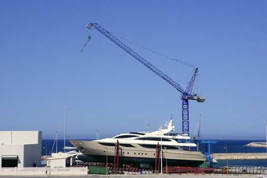 Beached boat with crane on storage area luxury yacht