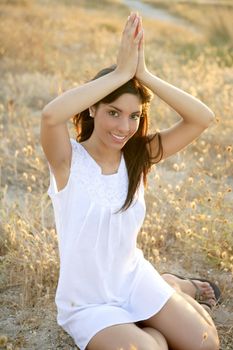 Beautiful indian brunette having a rest on a golden summer field