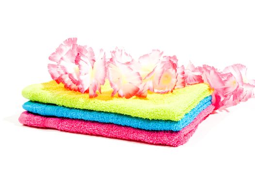 towels with flowers for spa activity isolated on white