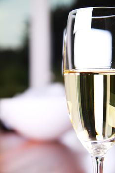 Close-up of a champagne glass on a mahoney table