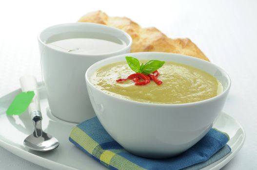 Bowl of homemade broccoli soup with green tea.