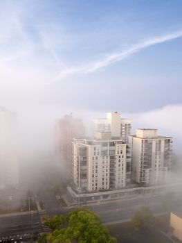 Summer fog rolling through a downtown neighborhood.