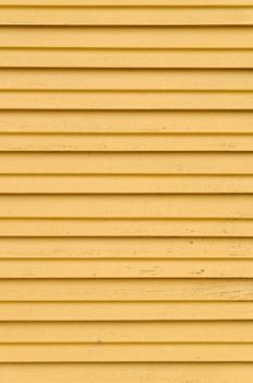 closeup detail of wooden yellow blinds - vertical shot