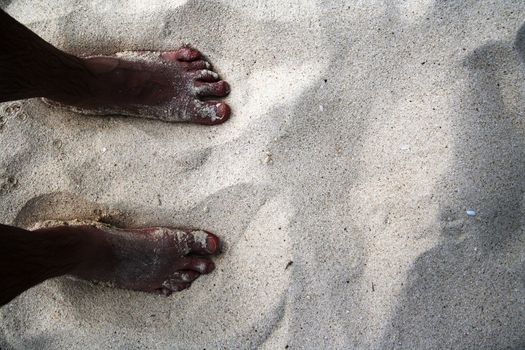 Feet on the beach in Aruba, Dutch Caribbean.