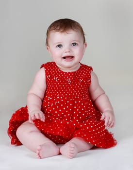 cute caucasian baby girl wearing red dress