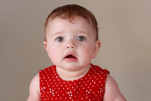 cute caucasian baby girl wearing red dress