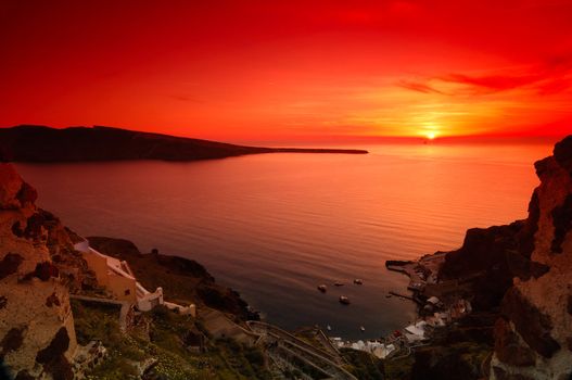 Image shows a spectacular sunset in the village of Oia, Santorini, Greece