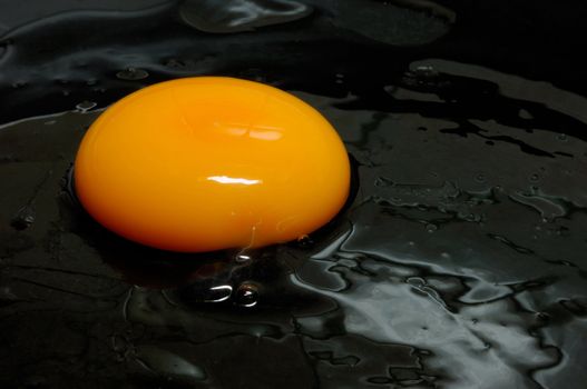 Image shows a raw egg being fried