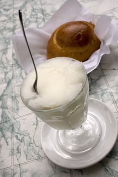 Granita and brioches, a typical sicilian dessert of water and lemon ice