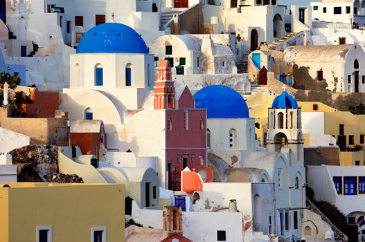 Image shows the village of Oia by day, on the beautiful island of Santorini, Greece