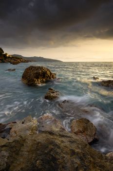 Image shows a rocky seascape near the city of Kalamata, Greece, during a windy afternoon