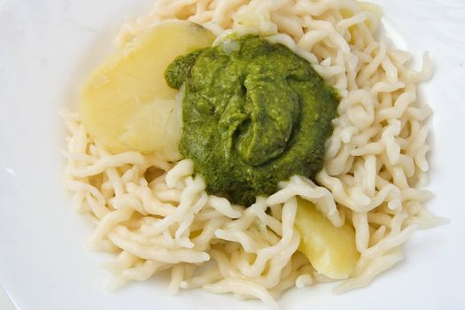 Trofie with pesto is a typical Ligurian food often accompanied by potatoes or green beans. Pesto is a sauce made of basil, parmesan and pine nuts