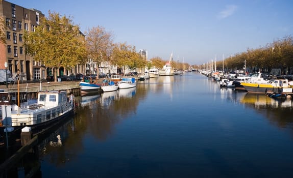 Blue and yellow autumn colors in harbour in october sun