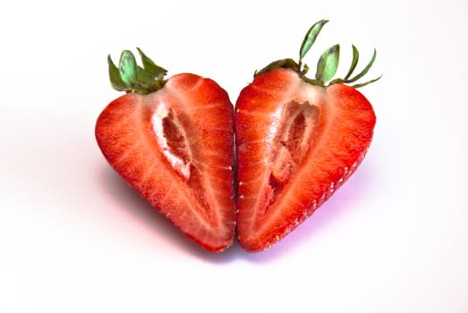 a strawberry split into two, with the two halves side by side. Macro photo