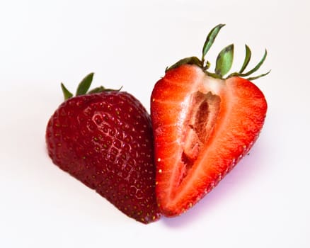 a strawberry split into two, with the two halves side by side. Macro photo