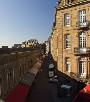 Road lined with small shops saint malo