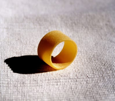 Italian macaroni on white tablecloth background