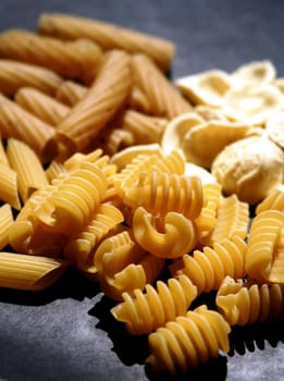 Variety of pasta on black background