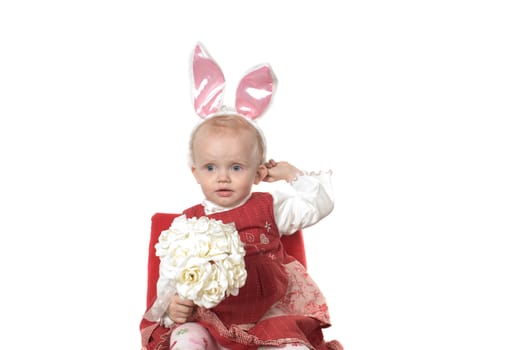 Closeup portrait of little girl with hare ears sitting on the chair