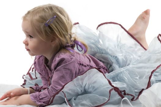 A little girl lying on the floor in studio