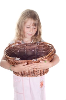 Shot of little girl playing with basket in studio