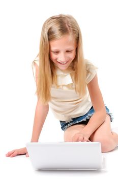 Happy little girl with laptop on white background isolated