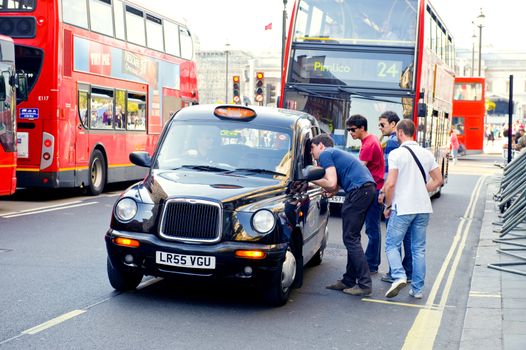 Red two-storeyed buses and taxi the symbols of London 