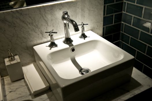 White bowl for washing of hands on a dark background 