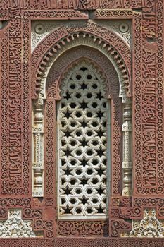 Qutb Minar Complex. Ornate stone window of ancient mosque. Delhi, India