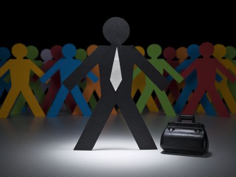 A paper businessman stands under the spotlight in front of multicolor crew.