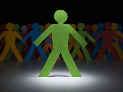 A green paper figure stands under the spotlight in front of multicolor crew.