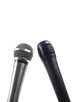 A black and a silver microphones isolated with copy space.