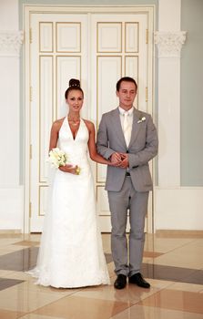 The bride and the groom in a hall of registration of a marriage