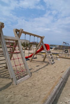 Children's playground on the beach. With cloudy skies in the background.