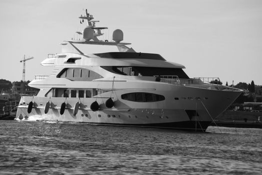 The luxurious yacht was photographed in black and white. Parked in the harbor.