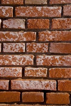 Old red brick wall fragment. Architectural background.