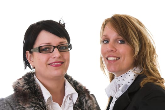 Two businesswoman standing together smiling on white background. One wearing glasses