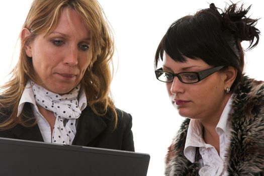 Two businesswoman together checking things on the laptop