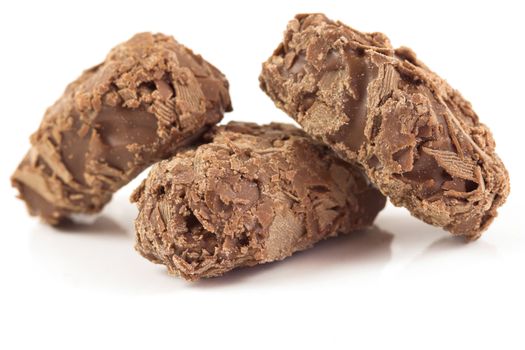 Three chocolate truffels together on white background