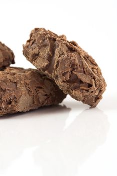 Delicious looking chocolate truffles on white background