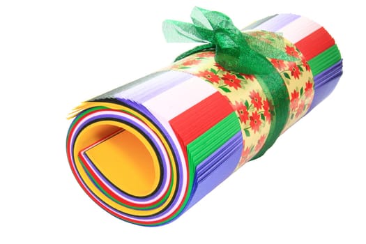 colored  roll of paper tied with green ribbon
