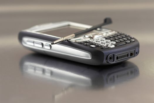 Modern PDA on shiny surface with shallow dof (focus on keypad)