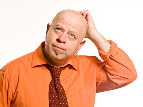 Bald man in an orange shirt and a red tie on a white background 
