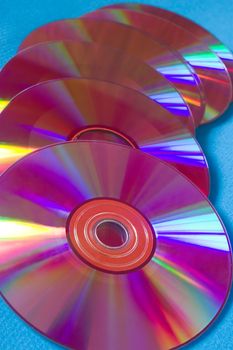 Six pink cd-disks on a blue background
