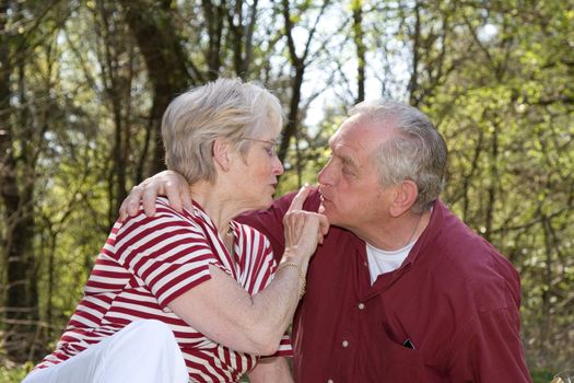 Sweet elderly couple outdoors on a hot summerday